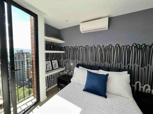危地马拉Hemen - Luxury Apartment with pool的一间卧室设有一张床和一个大窗户