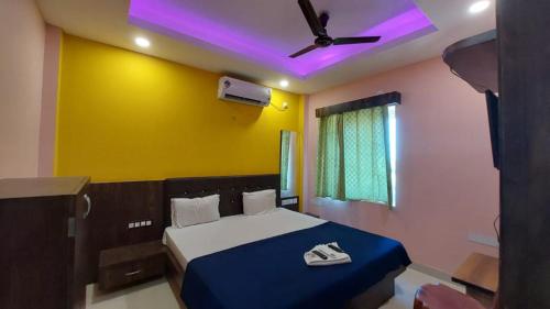 普里Hotel Jagdish Palace Puri的一间卧室配有一张床和吊扇