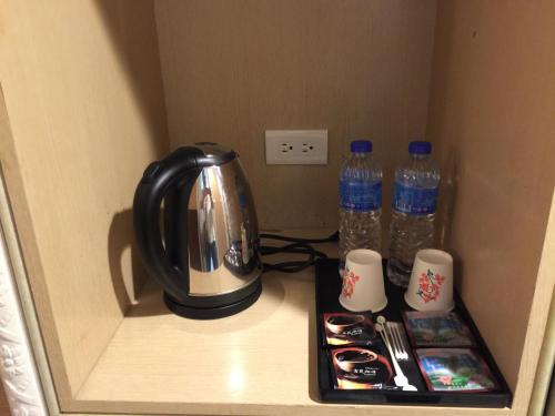 台北板桥王旅馆的架子上的咖啡壶和两瓶水