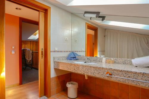 贝纳斯克HOTEL TURPÍ的一间带水槽和镜子的浴室