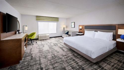 温莎汉普顿酒店及套房温莎酒店的酒店客房配有一张床、一张书桌和一台电视。