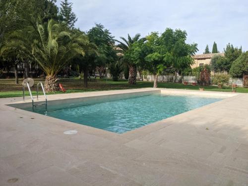 拉弗雷斯内达埃尔修道院1613酒店的棕榈树公园内的游泳池
