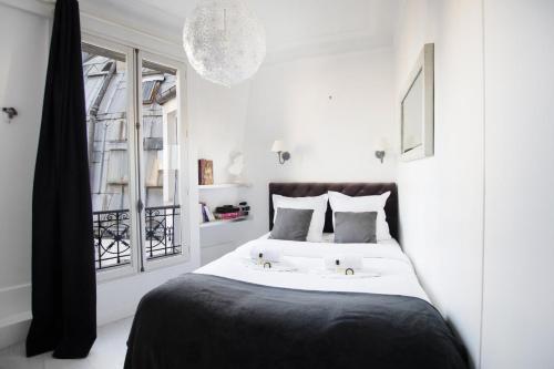 巴黎GuestReady - Cozy and Bright with Notre Dame View的卧室配有带白色墙壁和窗户的床