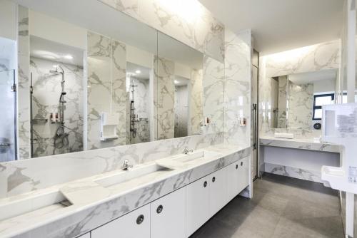 曼谷The Cube Hostel Silom的一间带两个盥洗盆和大镜子的浴室