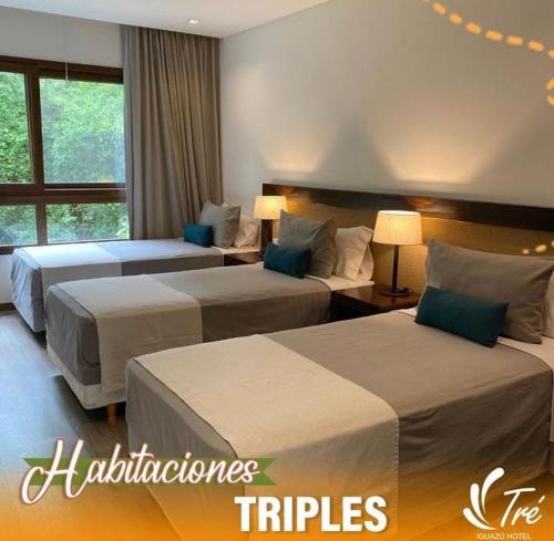 伊瓜苏港Hotel Tré Iguazú的酒店客房设有两张床和窗户。