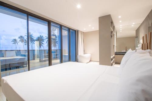 马塞约Maceio Mar Resort All Inclusive的一间大型的白色卧室,享有海景