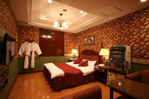 奈良D-CUBE奈良店的壁纸客房内的一间卧室配有一张床