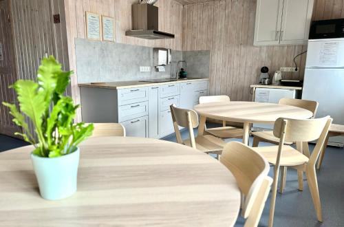 塔尔图Tamme staadioni hostel的厨房配有2张桌子和椅子以及冰箱