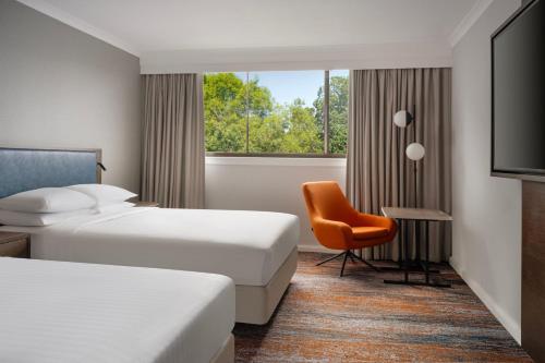 格拉斯哥万豪格拉斯哥酒店的酒店客房,配有两张床和椅子