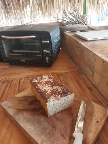 RincónHostel Nugeku的烤炉旁切板上的一块蛋糕