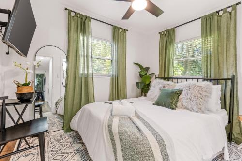 塔拉哈西Midtown Charm - Downtown, Fsu, Famu的一间卧室配有一张带绿色窗帘的床