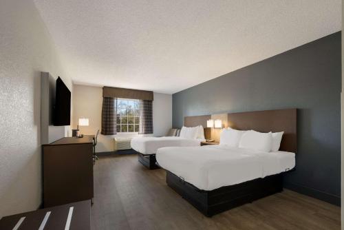 法姆维尔Quality Inn University Area的酒店客房设有两张床和窗户。