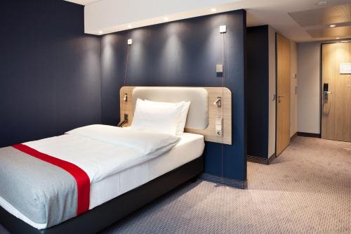 雷姆沙伊德Holiday Inn Express - Remscheid的一间卧室配有一张黑色墙壁的床