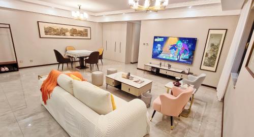 西安西安古城墙下您舒适的家的客厅配有白色沙发和电视