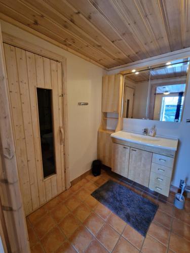 塔恩达勒Hamrahöjden - panoramavy & närhet till fjället的一间带水槽、镜子和门的浴室