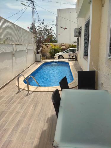 拉马萨Appartement maresoie的庭院中一个带桌椅的游泳池