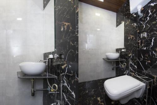 孟买Hotel New Blue Sapphire Residency的一间带两个盥洗盆和卫生间的浴室