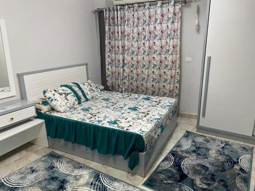 赫尔格达Small room的一间带床和窗帘的小卧室
