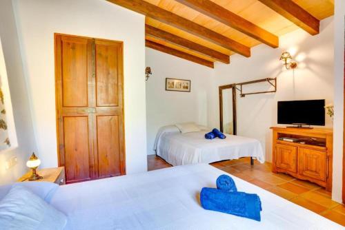 福纳卢奇Casita de Montaña cerca del mar的一间卧室配有两张床和一台电视。