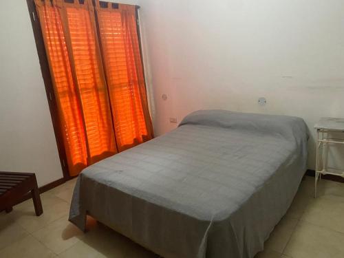 萨尔塔Casa Bella Vista的一间卧室设有一张床和一个橙色的窗户。