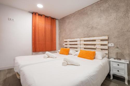 卡塔赫纳Att Cartagena Centro Histórico的一间卧室配有两张带橙色和白色枕头的床