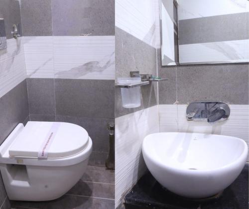 博帕尔HOTEL R K PALACE的浴室配有白色卫生间和盥洗盆。
