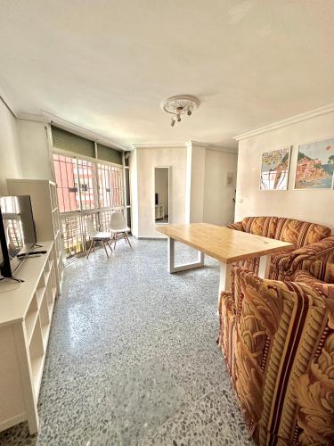 塞维利亚Apartamento en Sevilla的客厅配有沙发和桌子