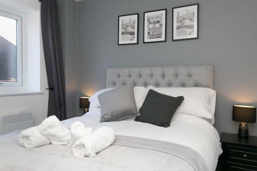 沃勒西Stunning 2 Bedroom Apartment in Wallasey的卧室配有白色的床,里面装满了动物