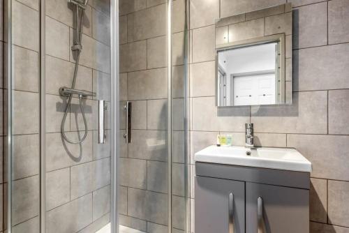 哈利法克斯Modern 1 Bed Budget Apartment in Central Halifax的带淋浴、盥洗盆和镜子的浴室
