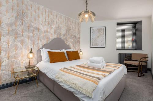 布莱克浦2bdr house - close to seafront的一间卧室配有一张带橙色枕头的大床