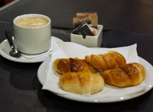 埃尔索韦维奥Hotel Don Enrique的桌上的一盘甜甜圈和一杯咖啡