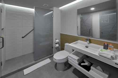坎昆City Express Plus by Marriott Cancun Aeropuerto Riviera的浴室配有卫生间、盥洗盆和淋浴。