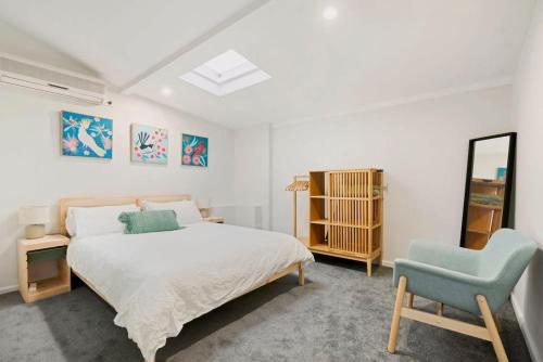 悉尼Cosy Camperdown的一间卧室配有一张床和一张蓝色椅子