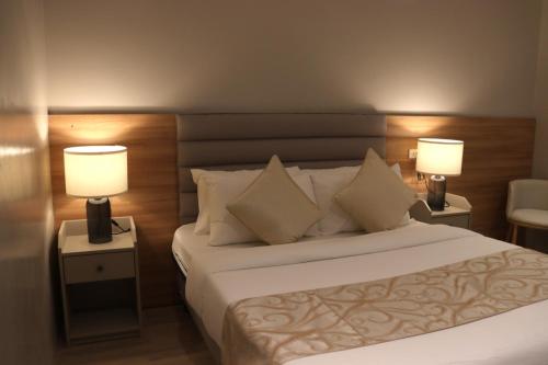 CavintiCaliraya Mountain Lake Resort的酒店客房,配有一张床和两盏灯