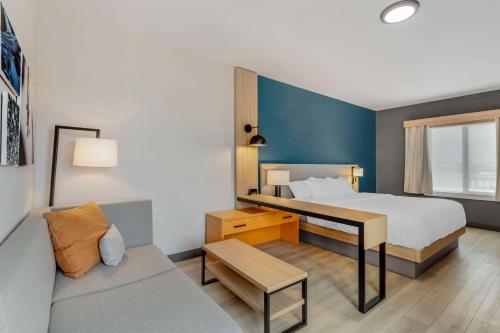 夏延Comfort Suites Cheyenne的酒店客房,配有床和沙发