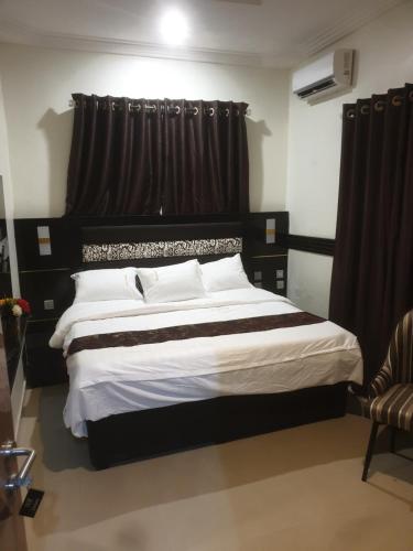 GwarinpaDownunder suites的一间卧室配有一张大床和黑色窗帘