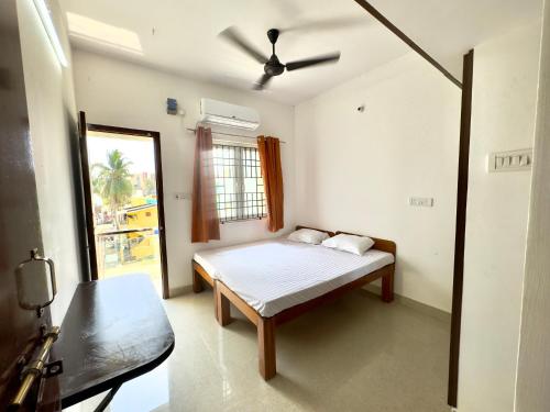 钦奈Sishya Service Apartment- 1bhk, IT Expressway, Thoraipakkam, OMR, chennai的一间卧室配有一张床和吊扇