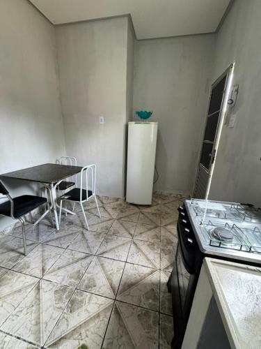 帕劳阿佩巴斯Condomínio Alencar的厨房配有桌子和白色冰箱。