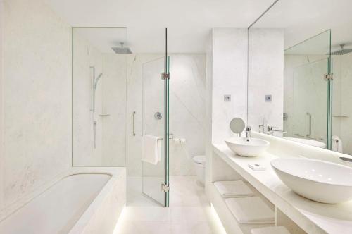 马德里马德里格兰大街中心凯悦酒店的白色的浴室设有浴缸和水槽。