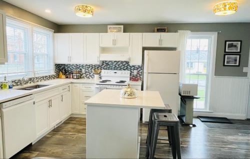 皮克顿Mileva Retreats的厨房配有白色橱柜和白色冰箱。