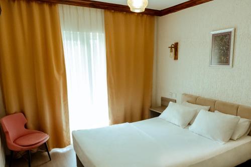 卡特佩ALEX VİLLAGE LİFE的卧室配有床、椅子和窗户。