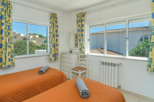 卢斯Casas do Ramalhete的一间卧室设有两张床和窗户。