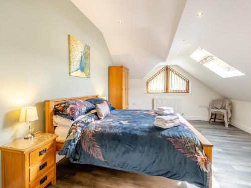 LlanafanDerwen Haidd的一间卧室配有一张大床和一个木制梳妆台