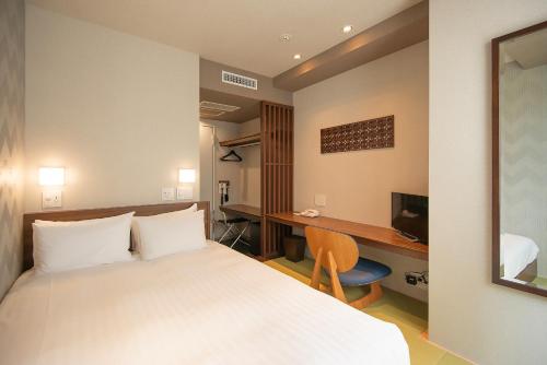 静冈阿本特静冈酒店的配有一张床和一张书桌的酒店客房