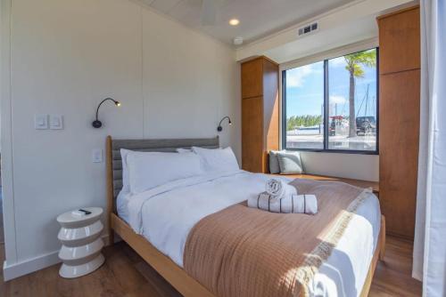 基韦斯特Awai's Floating Villa - Houseboat in Luxury Village的一间卧室设有一张大床和大窗户