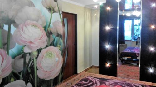 尼古拉耶夫Apartment Admiralskaya的浴室内装有镜子,上面有粉红色的鲜花