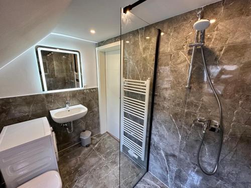 汉诺威Durmaz Hotel的带淋浴、卫生间和盥洗盆的浴室