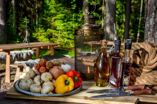哈瑟拉Glamping in Wilderness的一张桌子,上面放着一盘蔬菜和瓶装葡萄酒