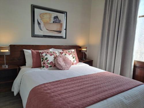 圣地亚哥Hotel Casa Aure的一间卧室配有一张带枕头的大床
