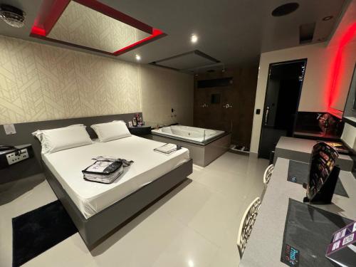 圣保罗Prestige Motel 3的一间卧室配有一张床和一个浴缸